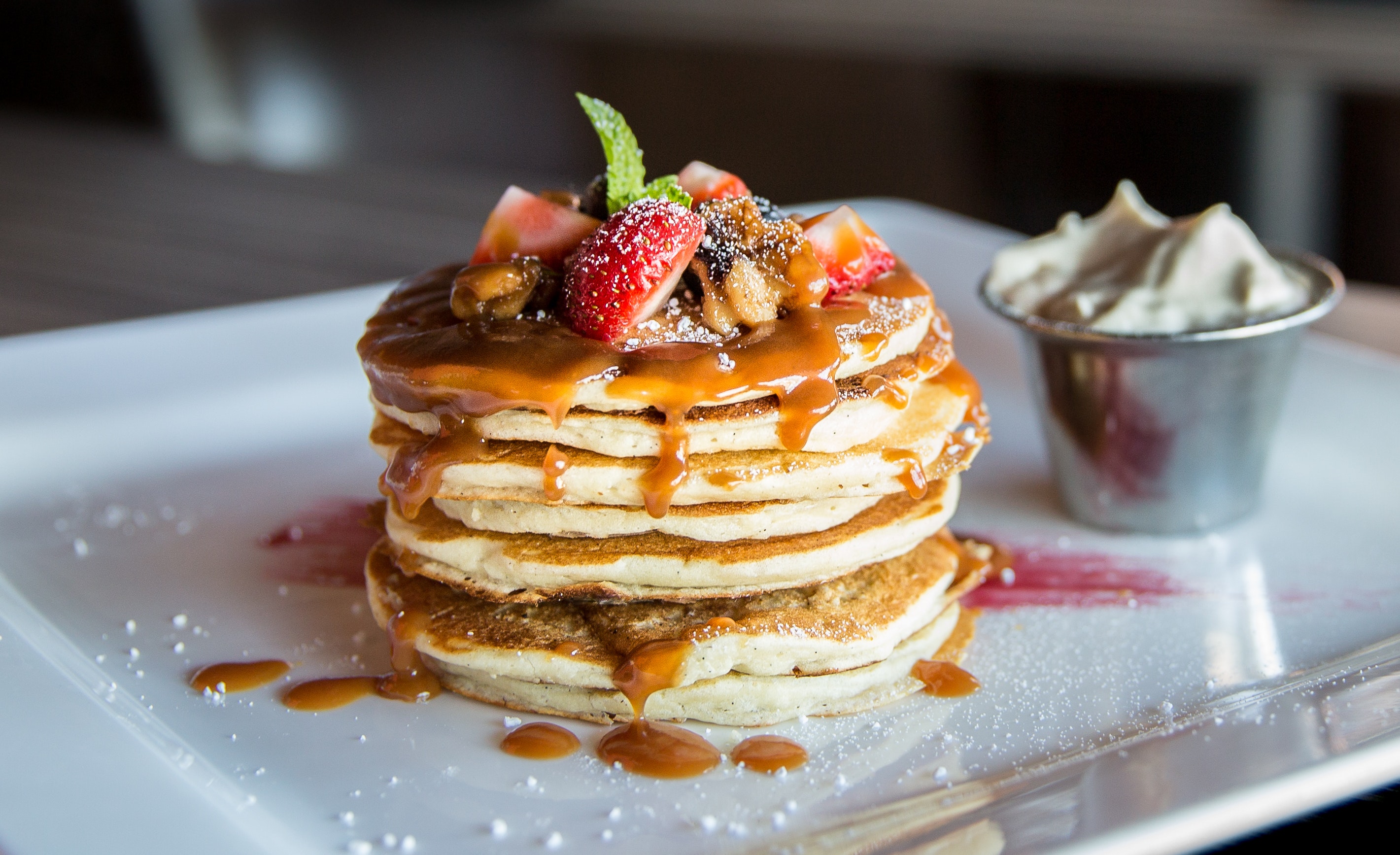 Pancakes with caramel sauce, berries and wipped cream